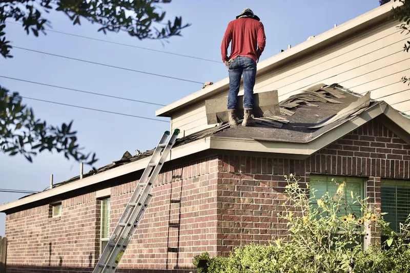 Professional roofer working on a residential roof in Wholesale District